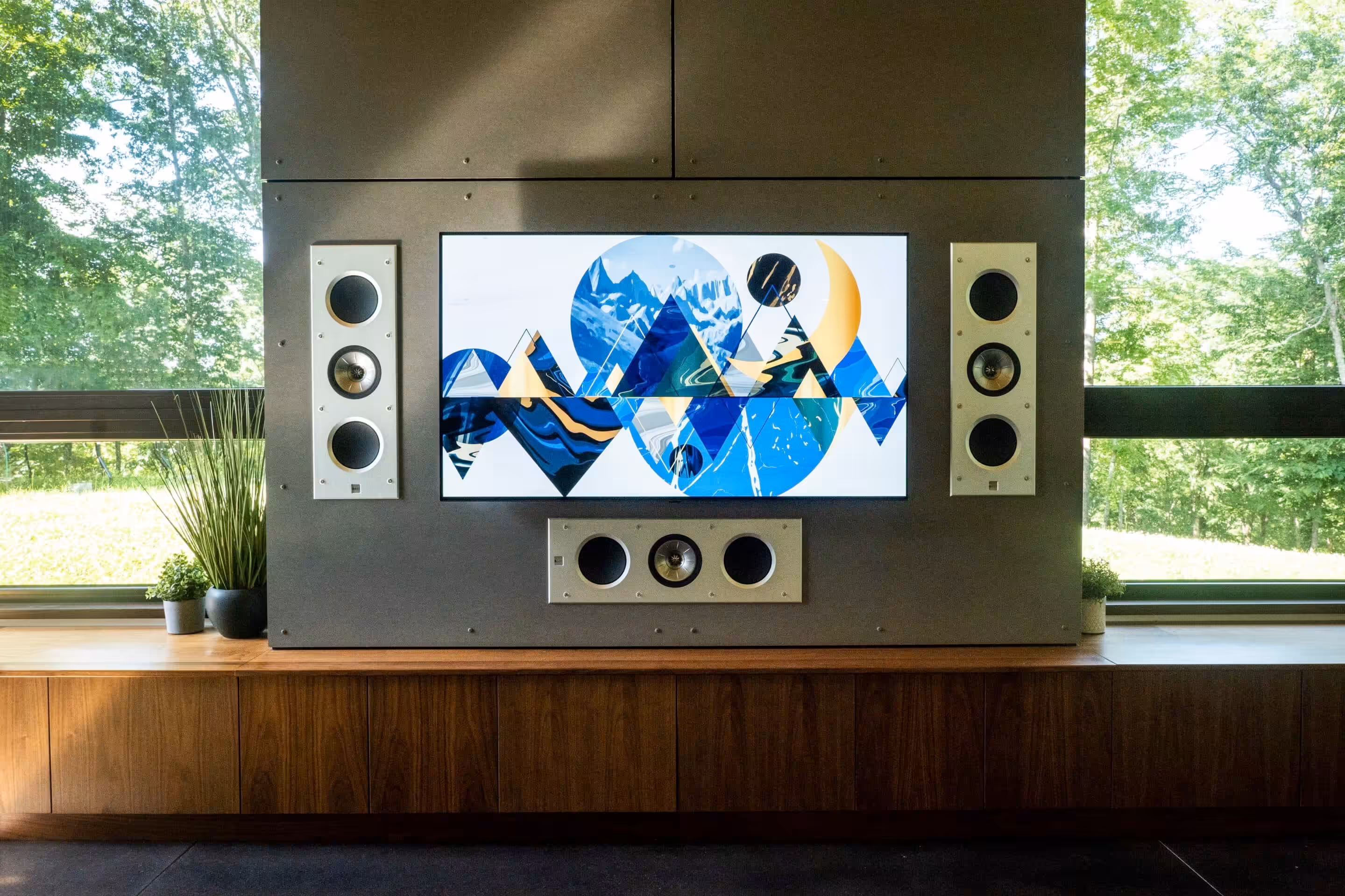 Audilux_LG_KEF_Install_NoGrills Television and in-wall LCR speakers, grilles off, on a dark media wall