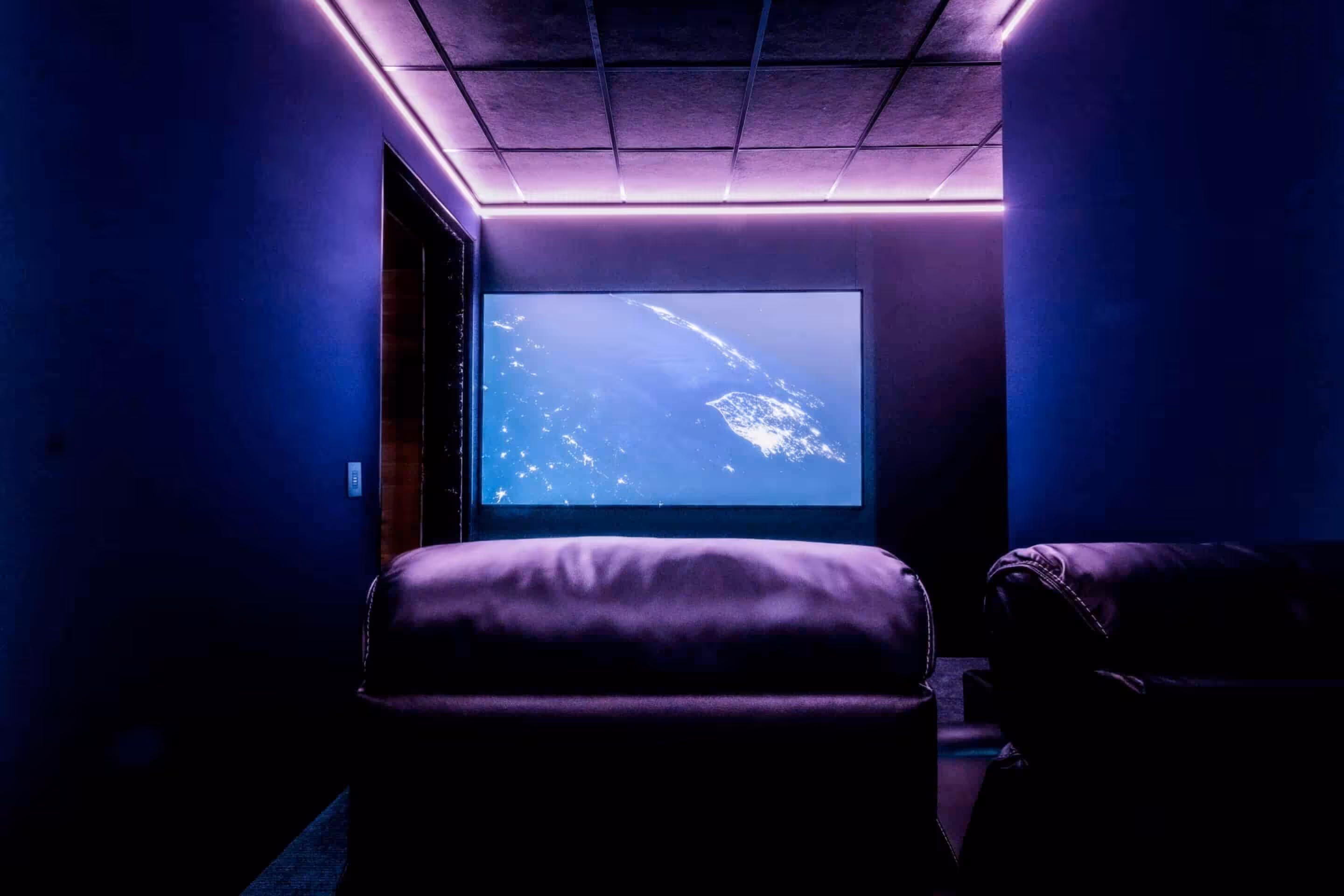 Acoustically transparent screen in a dedicated home theater